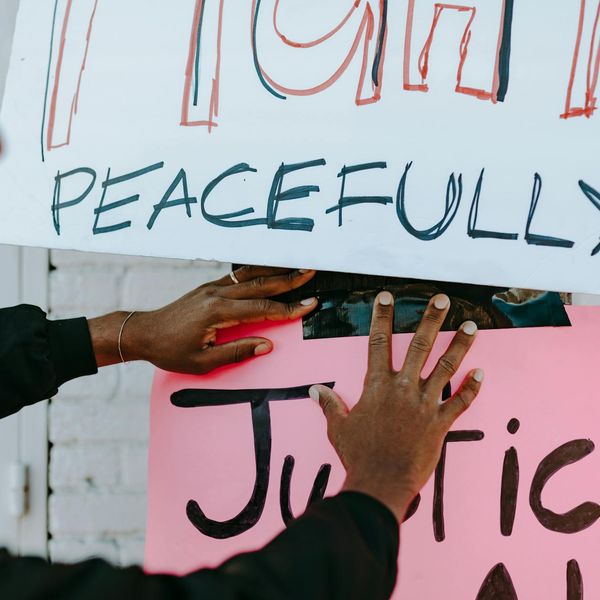 Person meditating peacefully in a serene natural environment.